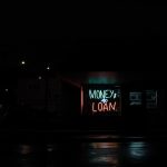 a neon sign is lit up in the dark