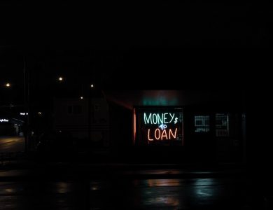 a neon sign is lit up in the dark