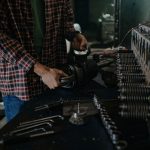 Mechanic using tools in an auto repair workshop for vehicle maintenance.